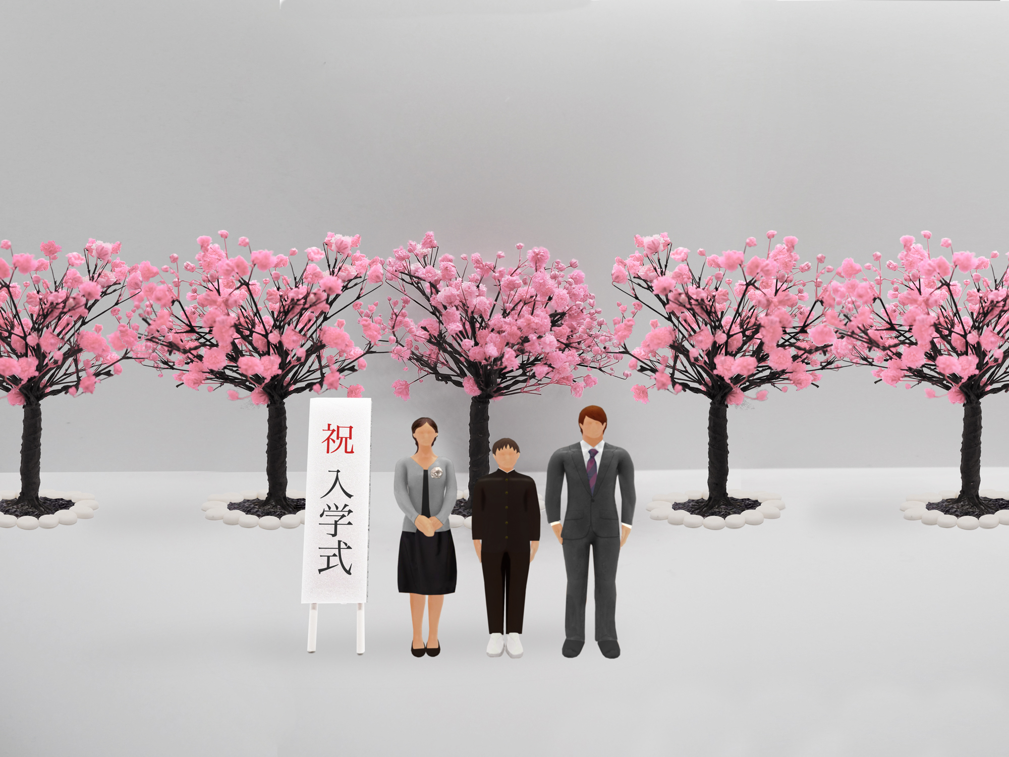 中学校の入学式で桜の木の前で撮影している家族のイメージ